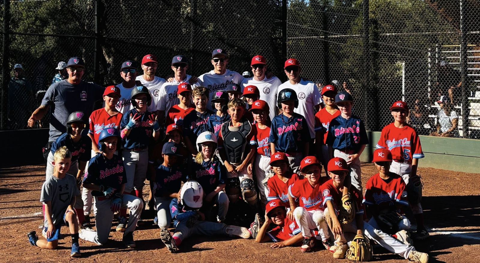 Rivals players and coaches in a big group photo with the opposing team after a game
